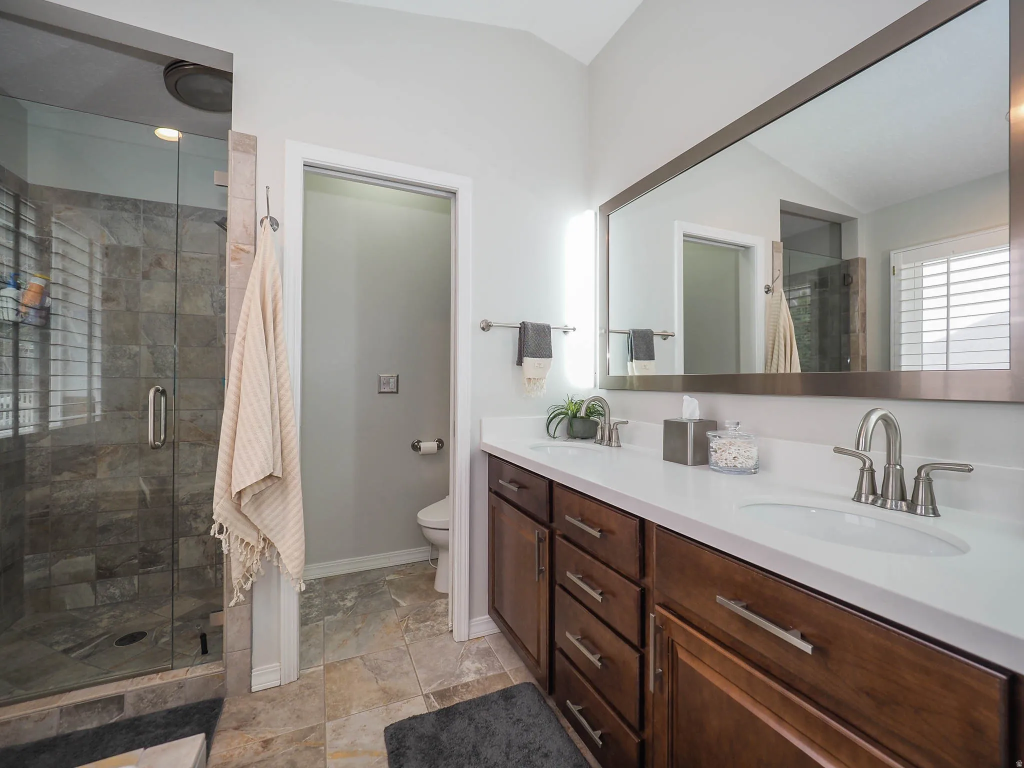 Primary En Suite Sanctuary with Relaxing Jetted Tub, Lovely Glass Enclosed Separate Shower, Newer Luxurious Bidet Feature, Convenient Double Sinks, Lush Newer Silestone Countertop, Attractive Newer Mirror, LED Lights & More!