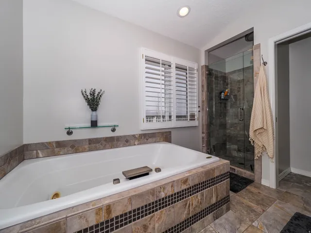 Primary En Suite Sanctuary with Relaxing Jetted Tub, Lovely Glass Enclosed Separate Shower, Newer Luxurious Bidet Feature, Convenient Double Sinks, Lush Newer Silestone Countertop, Attractive Newer Mirror, LED Lights & More!