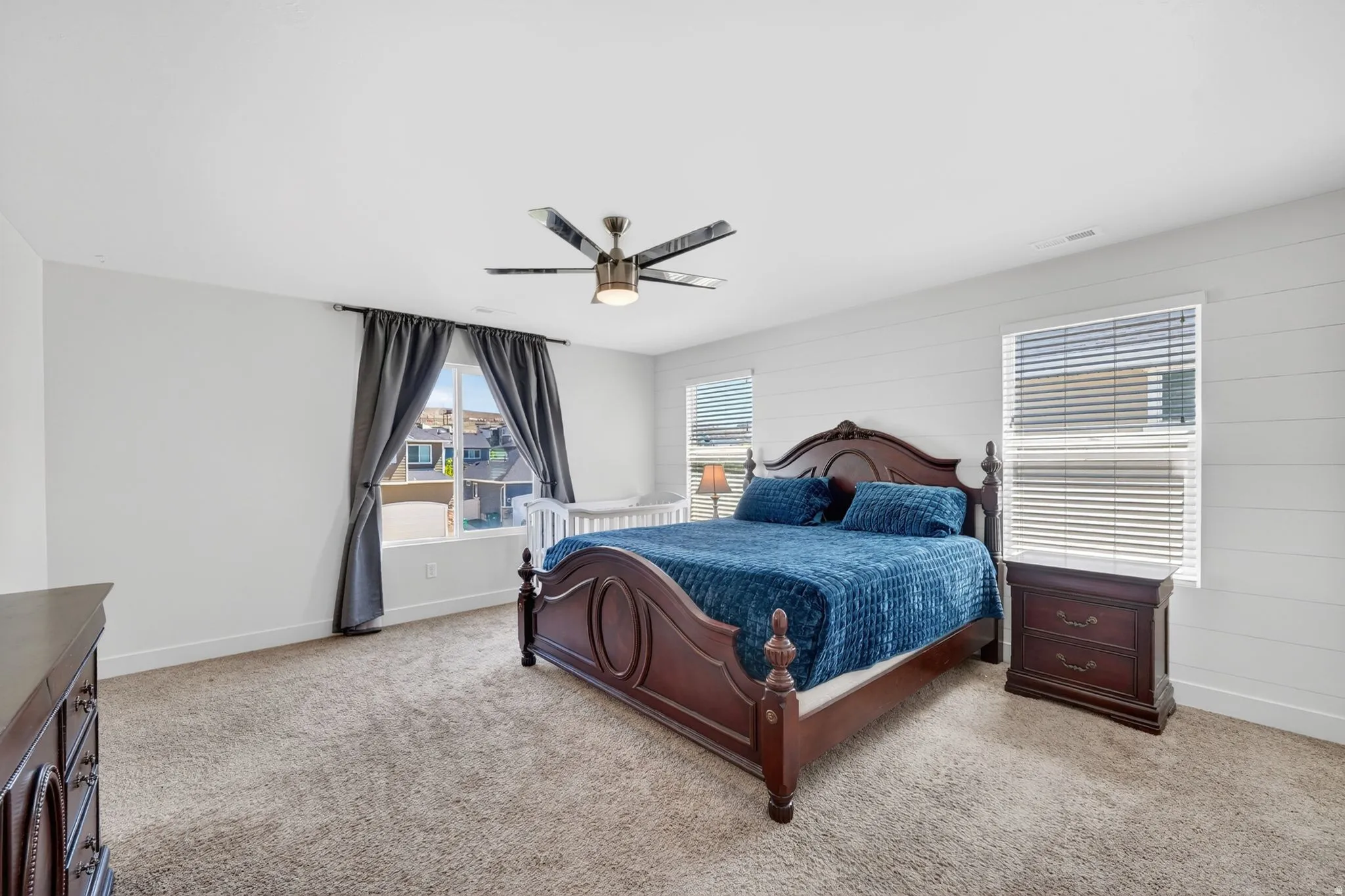 Spacious room featuring neutral carpeting and white walls