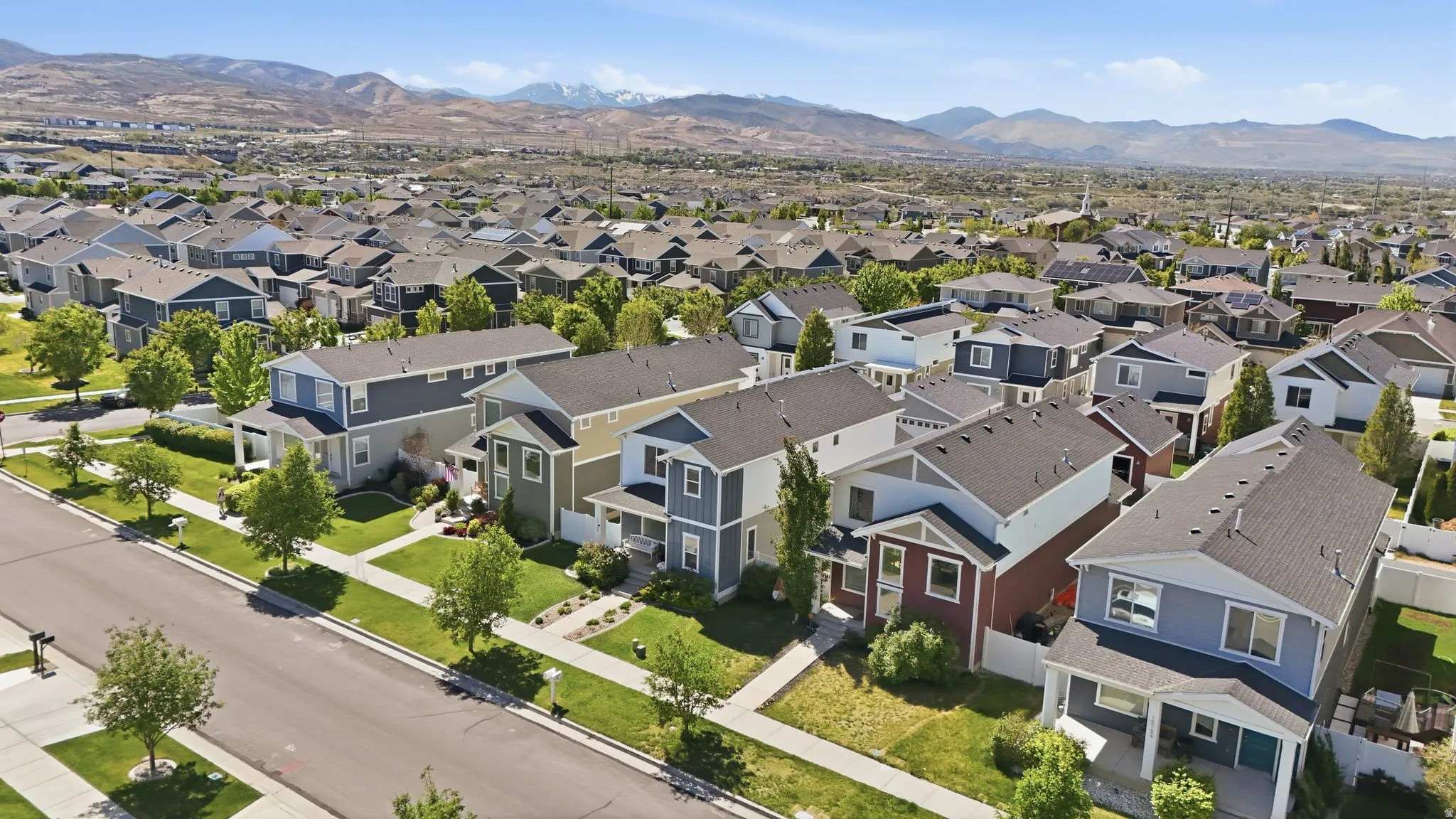 Residential development featuring modern homes with varying exterior finishes and asphalt shingle roofs