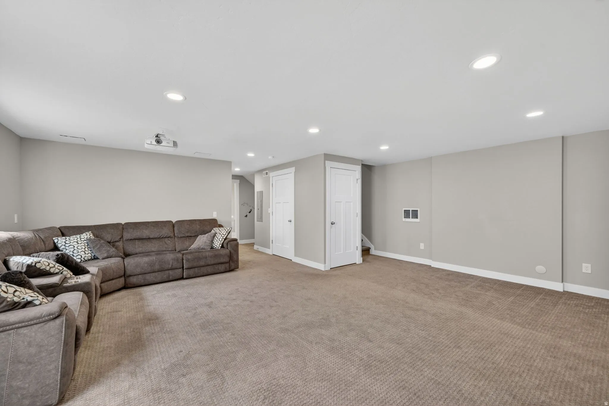 Spacious finished interior room featuring recessed lighting, light gray wall tones, and carpet flooring