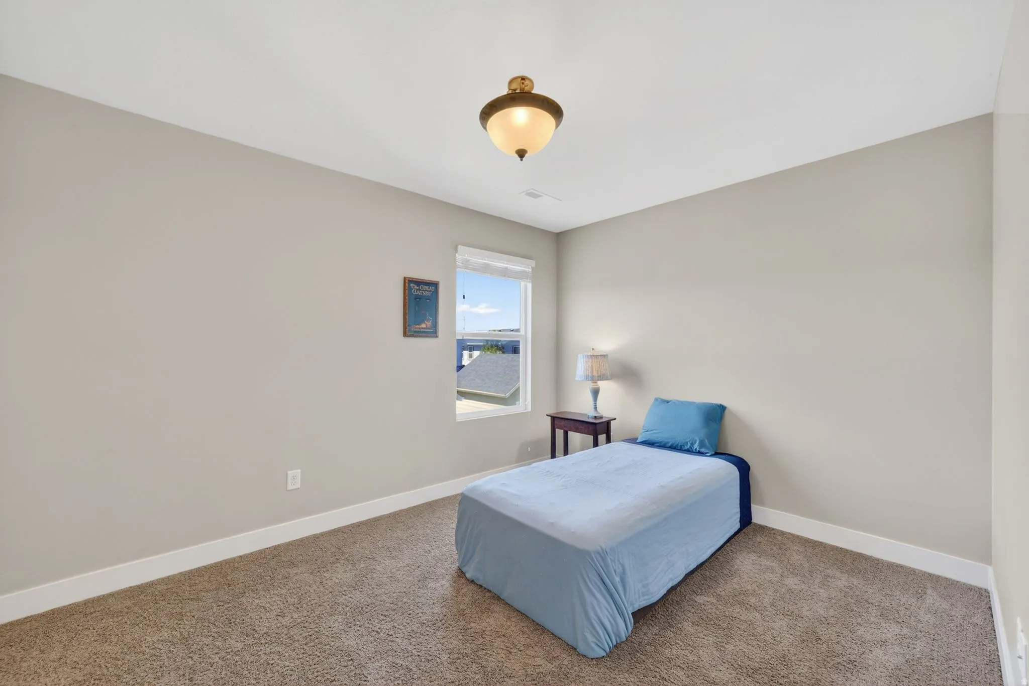 Carpeted room with a single window and recessed lighting