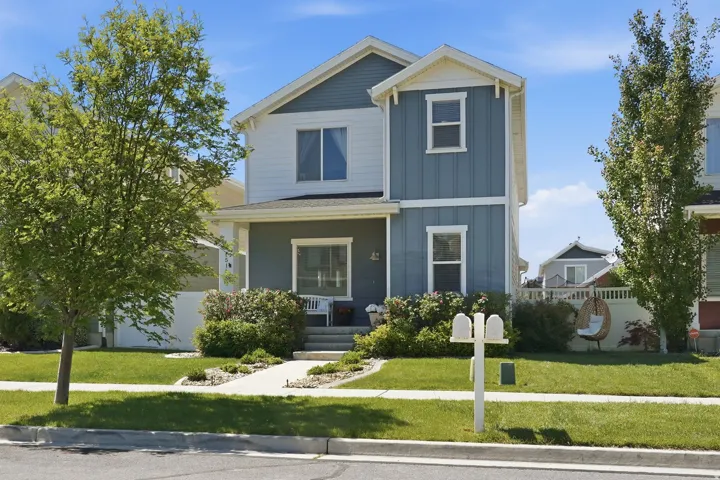 Two-story residence featuring a combination of blue siding and white trim