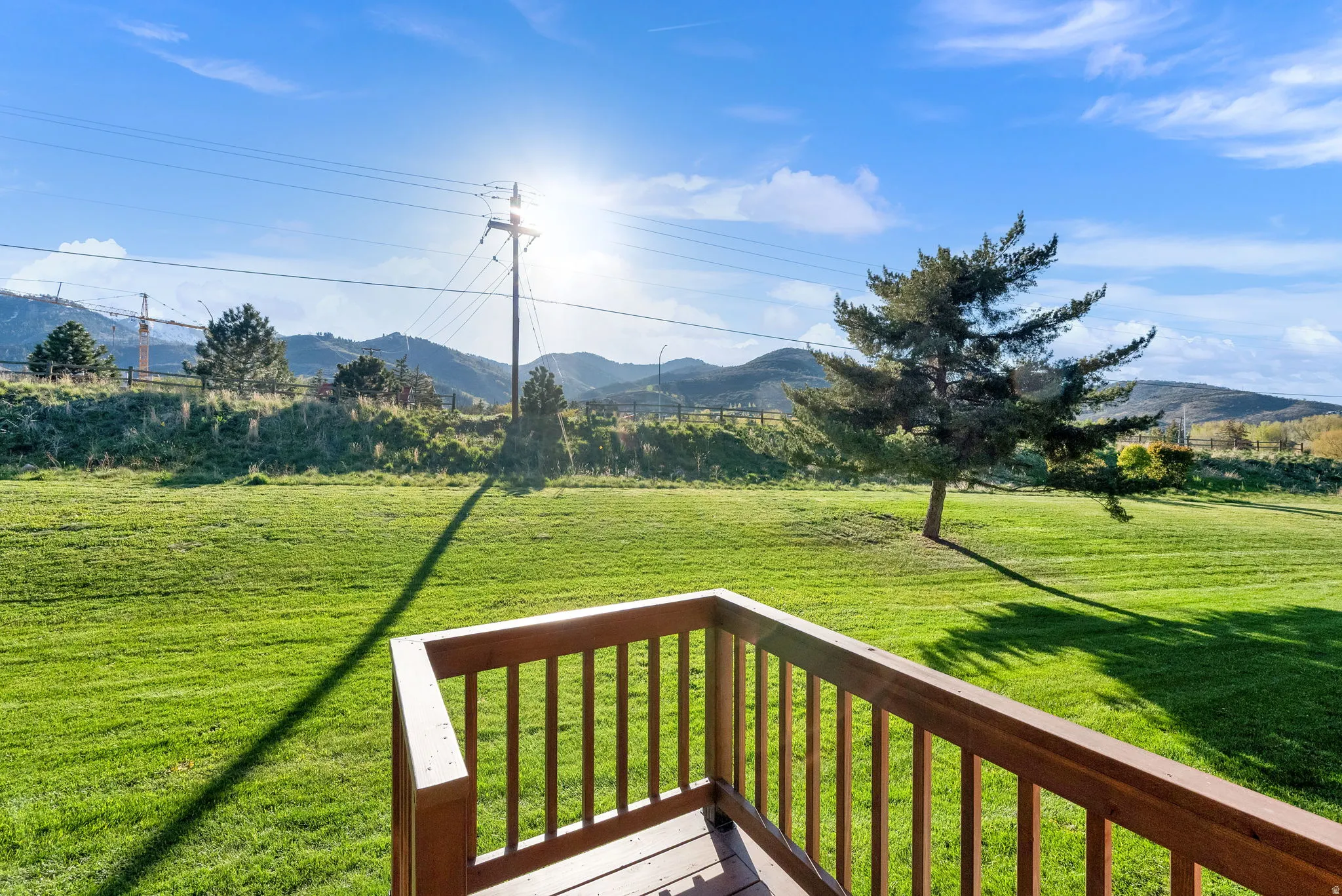 Expansive green lawn with mountain backdrop