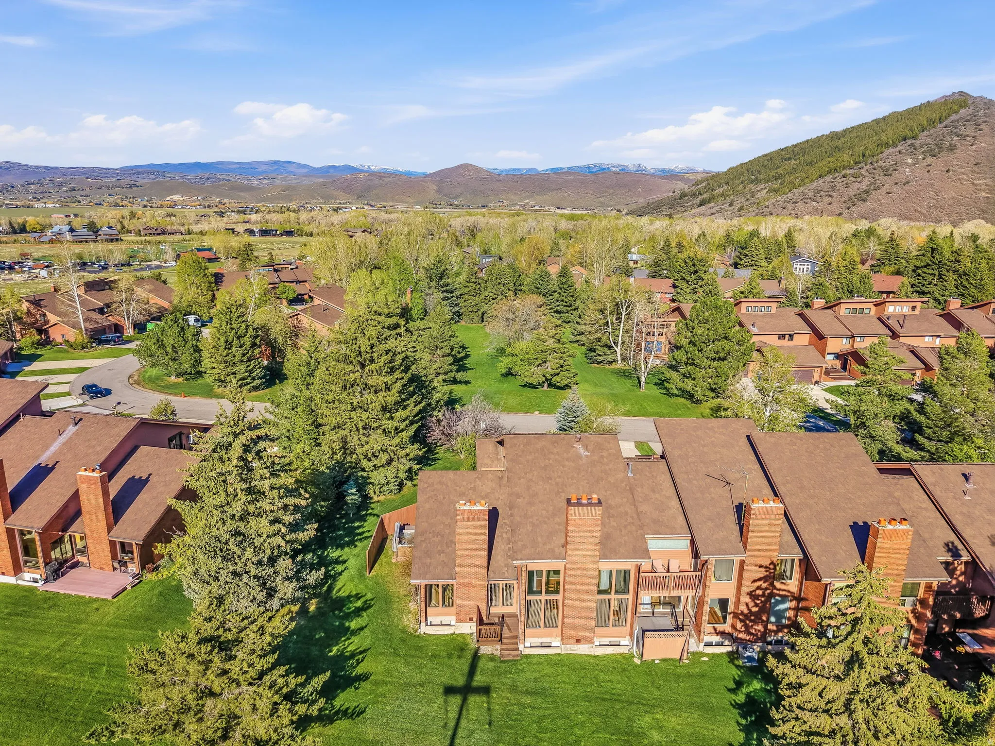 Townhome community with terracotta roofs and brick chimneys