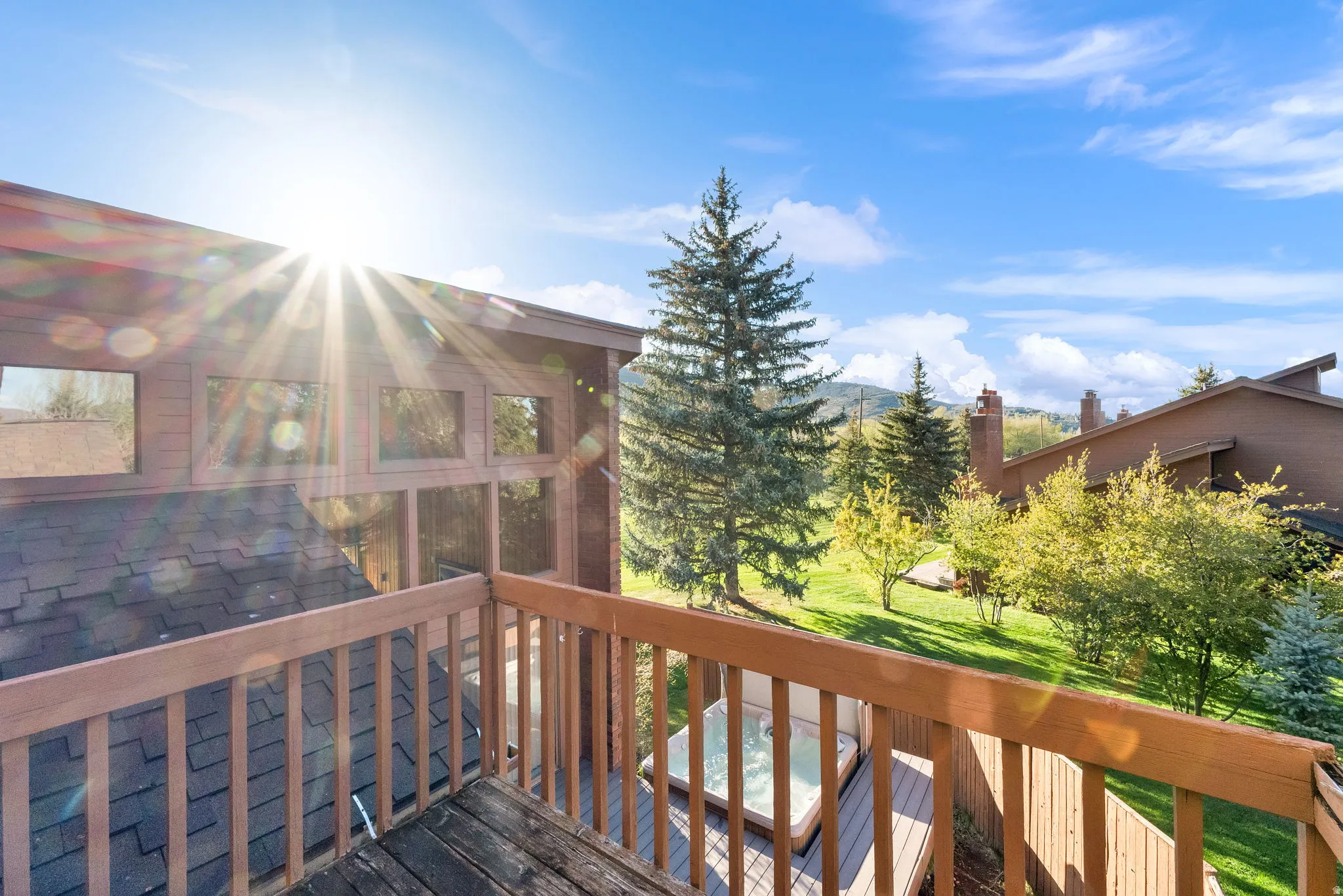 Upper-level balcony featuring wooden railings and decking
