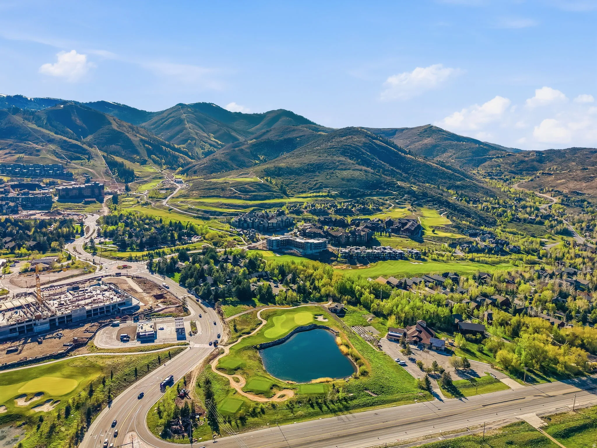Expansive aerial showcasing a mountainous landscape with verdant slopes