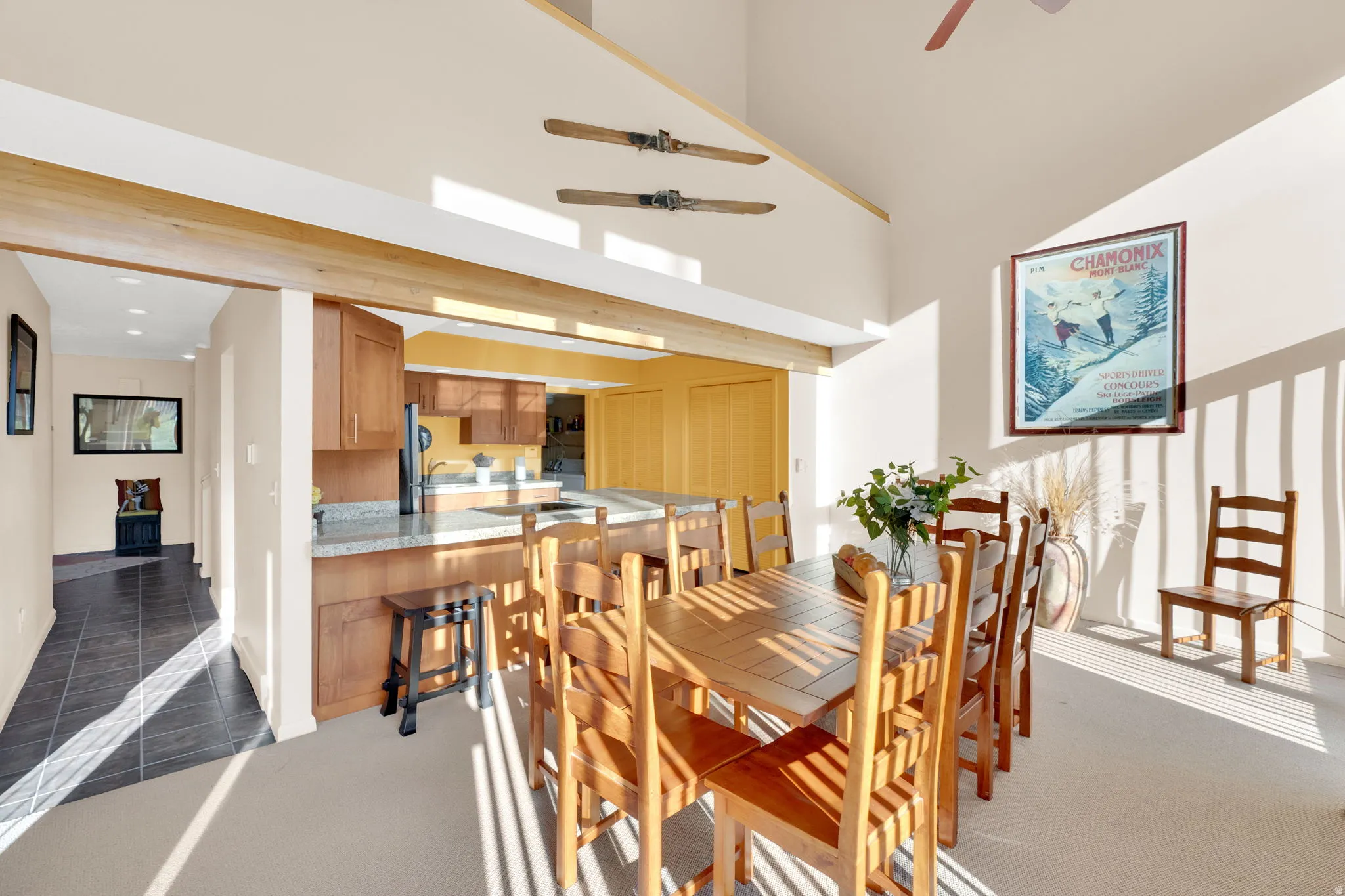 Open-concept dining area with vaulted ceilings and exposed wood beams