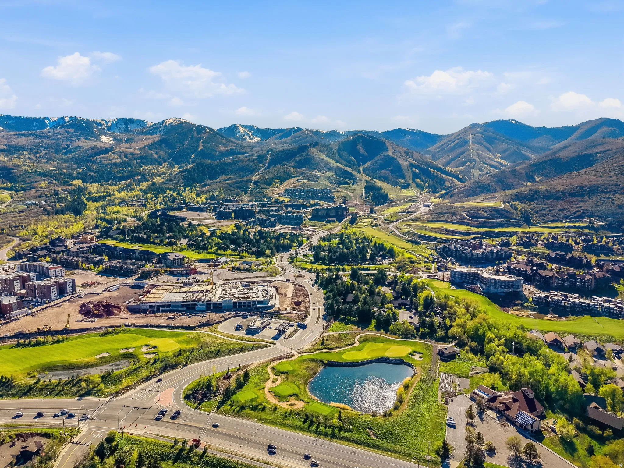 Expansive mountain landscape featuring snow-capped peaks and verdant valleys