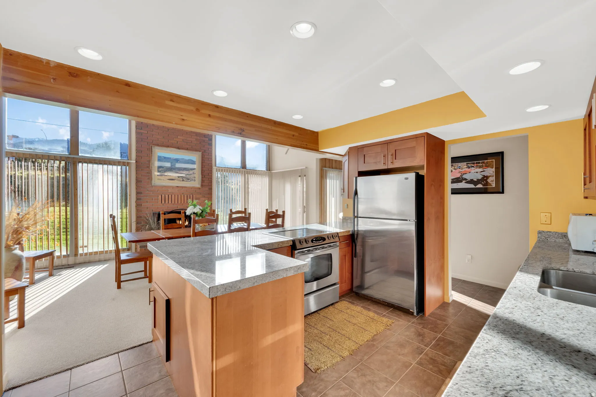 Kitchen featuring wood cabinetry, stainless steel appliances, and granite-look countertops