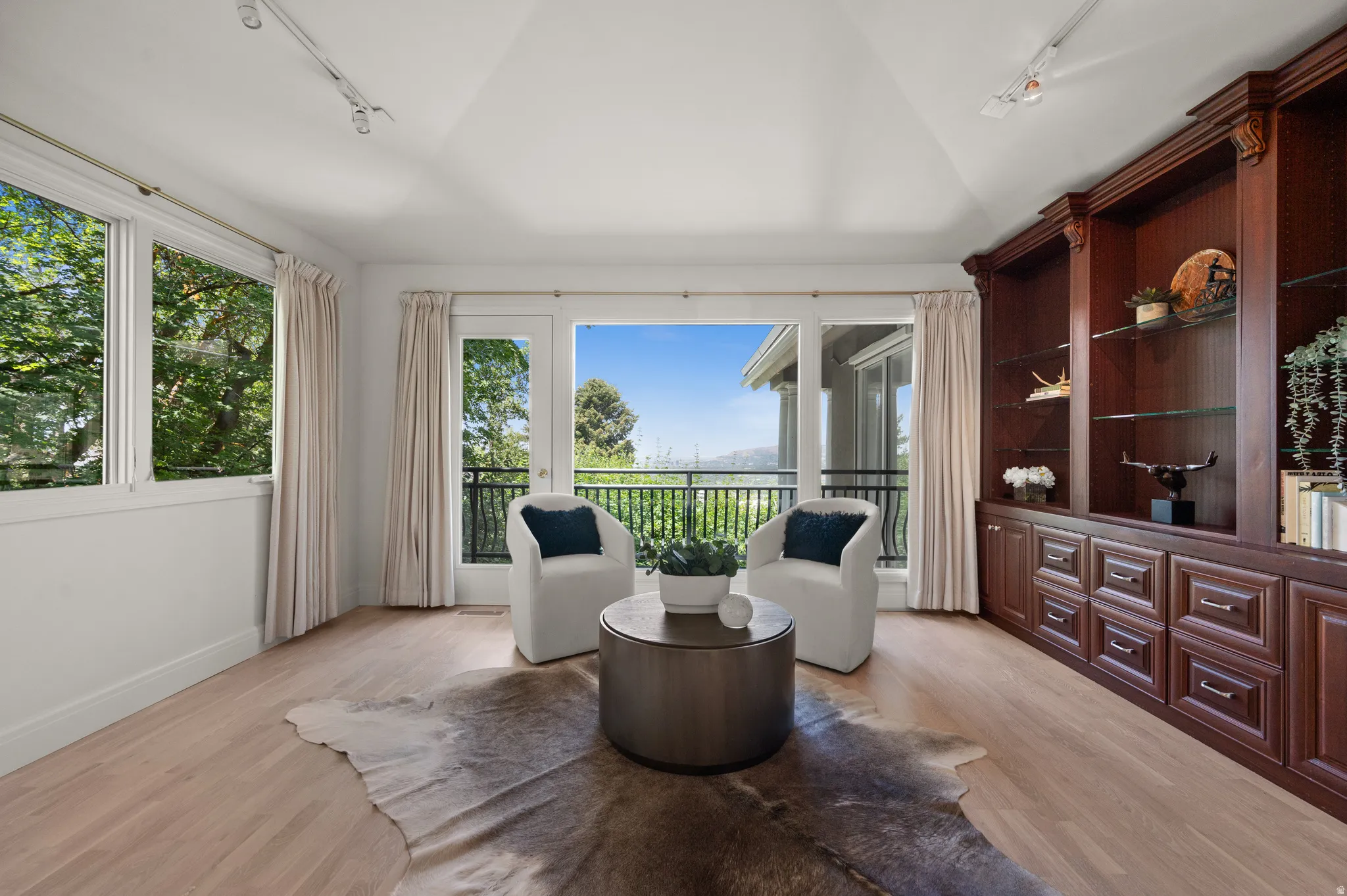 Room featuring vaulted ceilings and light wood-finish flooring