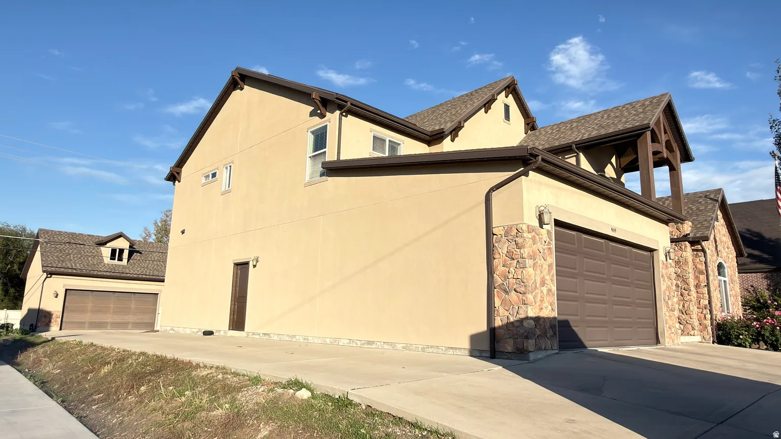 View of home's exterior featuring a garage and driveway
