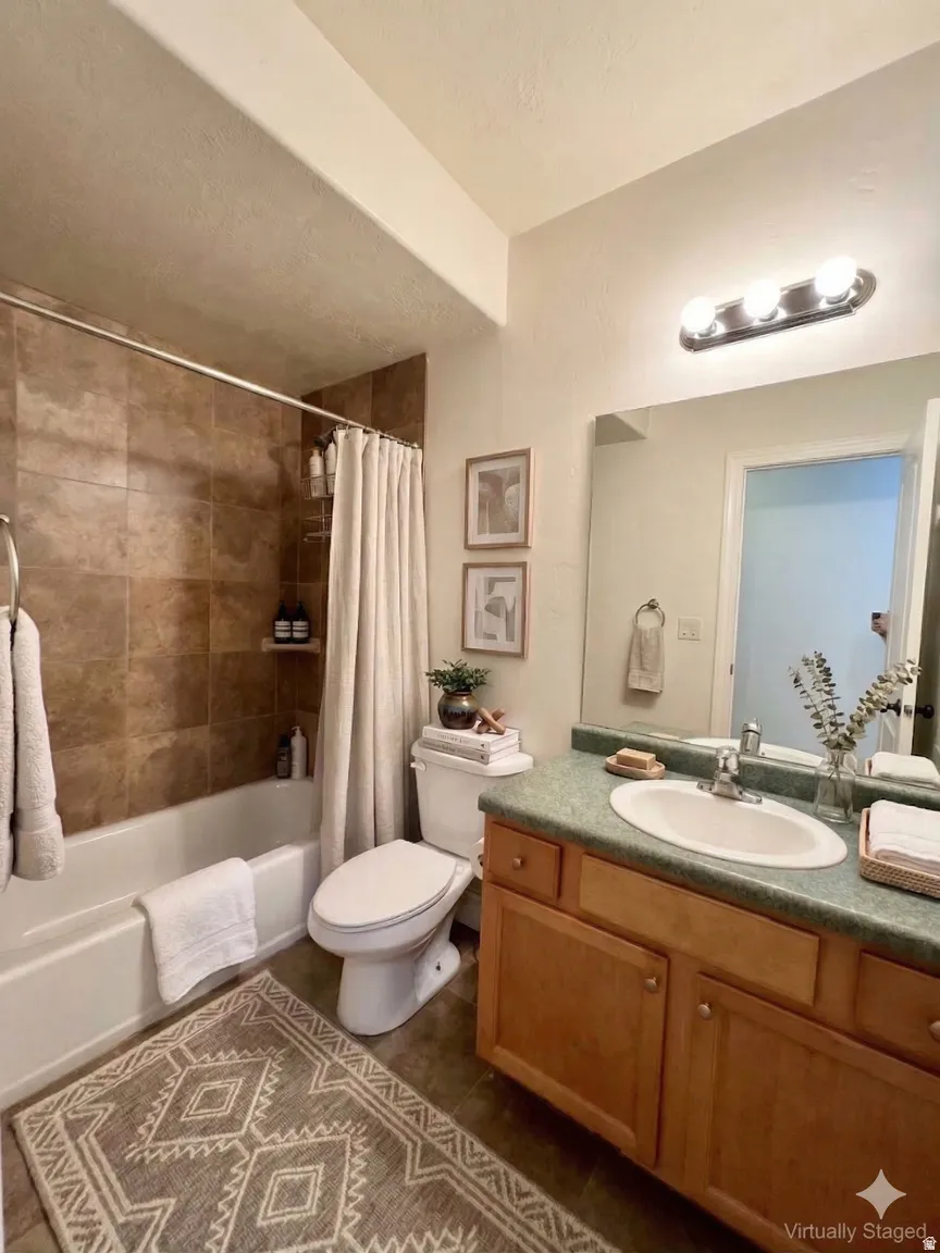 Bathroom with vanity and shower / bathtub combination