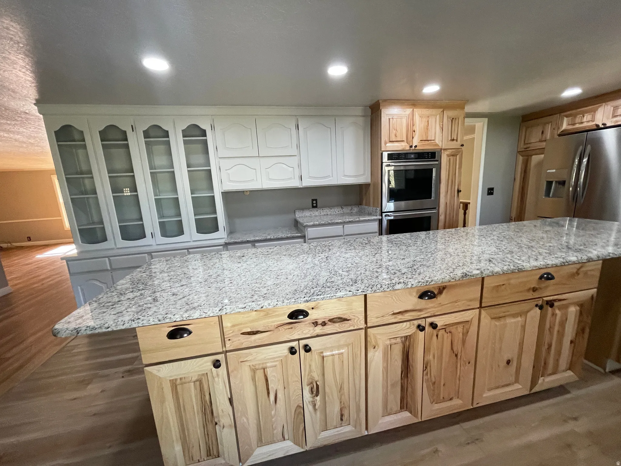 Spacious kitchen featuring a large island with light-toned wood cabinetry and ample countertop space