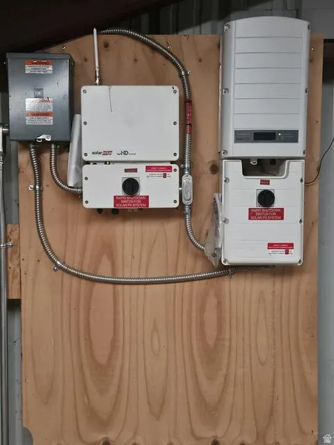 Solar PV system components mounted on a plywood backboard