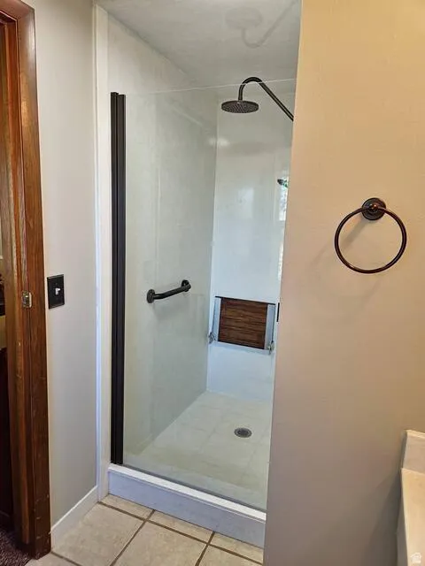 Walk-in shower with clear glass enclosure and black hardware