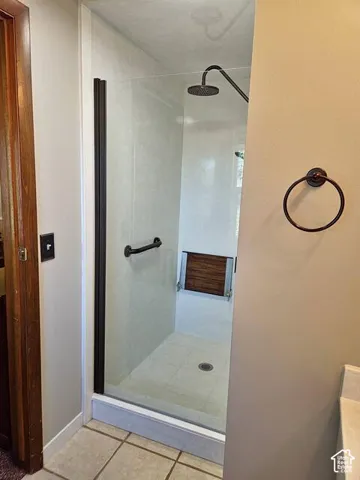 Walk-in shower with clear glass enclosure and black hardware