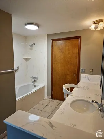 Bathroom vanity featuring a single integrated sink with chrome faucet