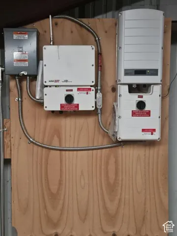 Solar PV system components mounted on a plywood backboard