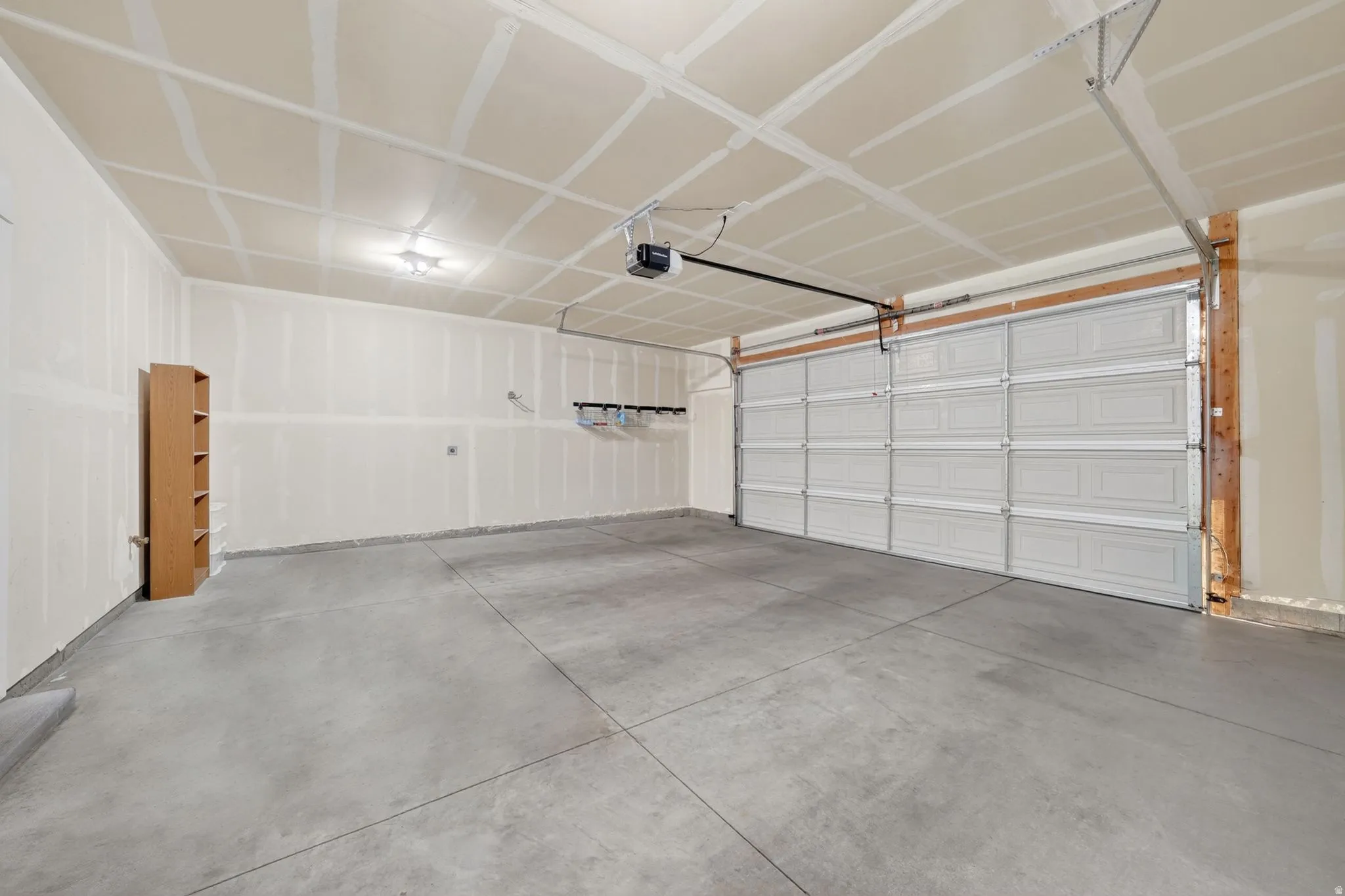 Spacious garage with a concrete floor, overhead lighting