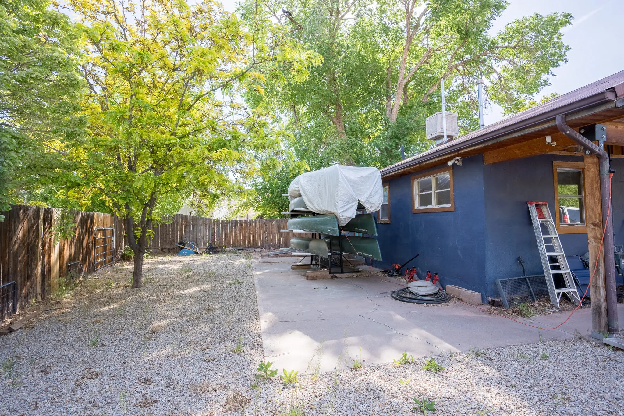Fenced backyard with a patio