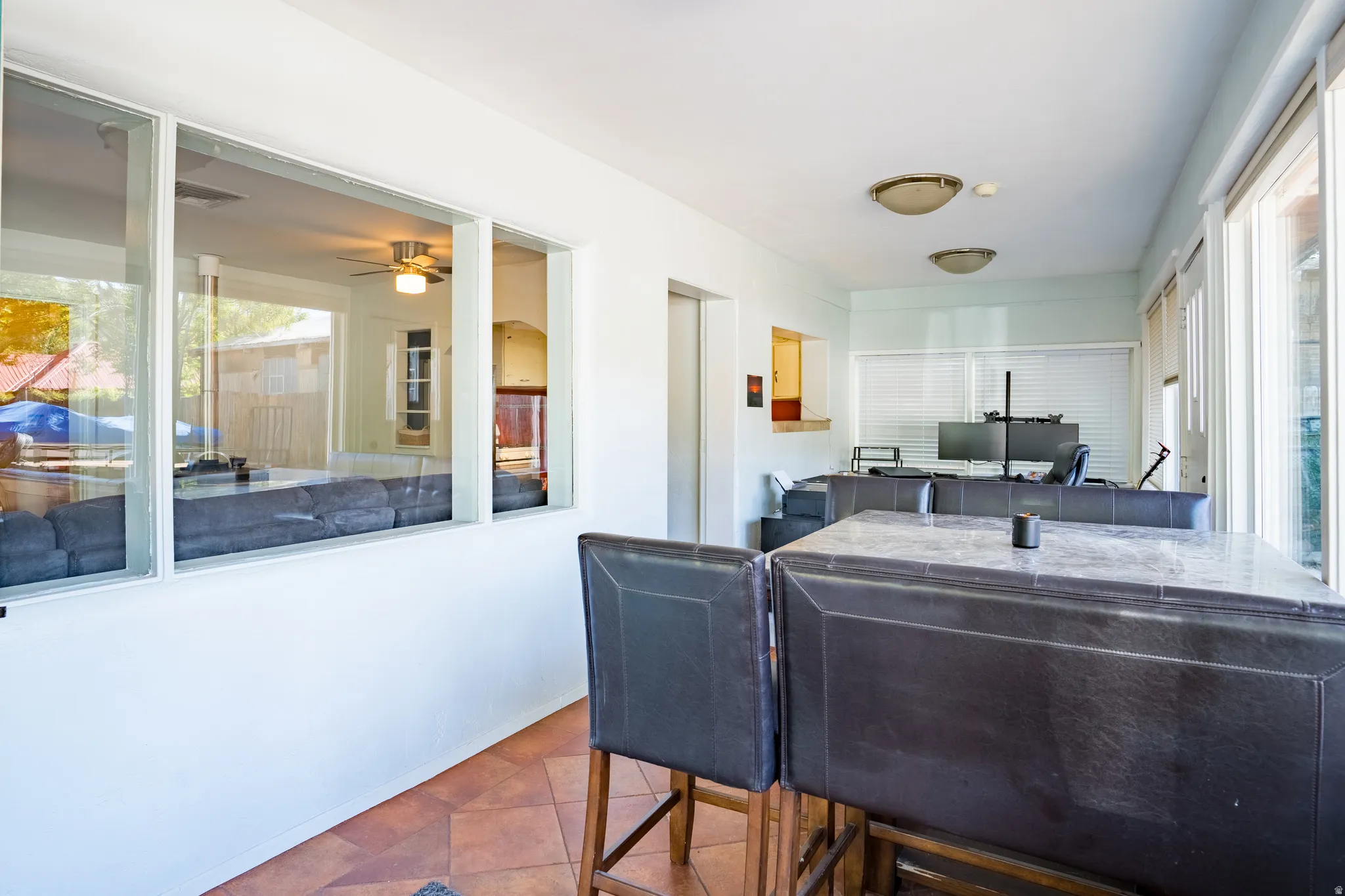 Sunroom / solarium featuring healthy amount of natural light and tile patterned floors