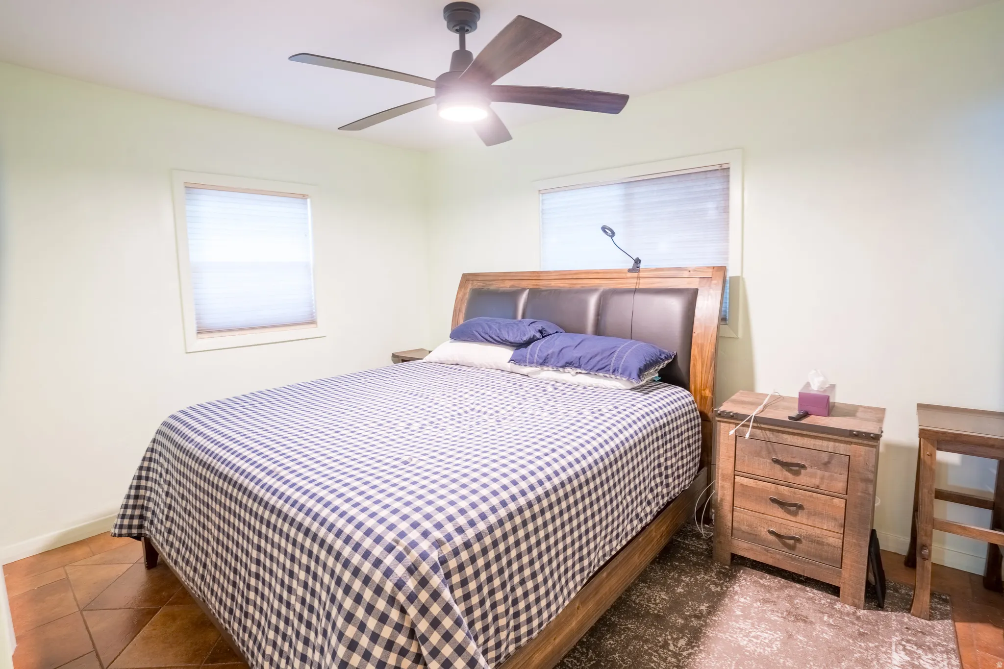 Bedroom with ceiling fan and baseboards