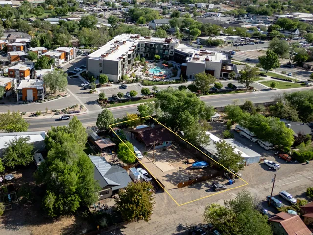 Aerial view showcasing a rectangular lot with a single-story structure and ample open space