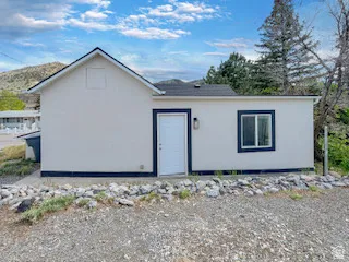 Contemporary exterior with white siding and dark trim