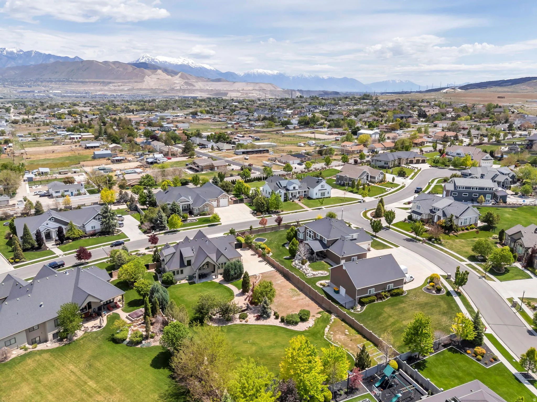 Expansive suburban neighborhood featuring manicured lawns, mature landscaping, and paved streets