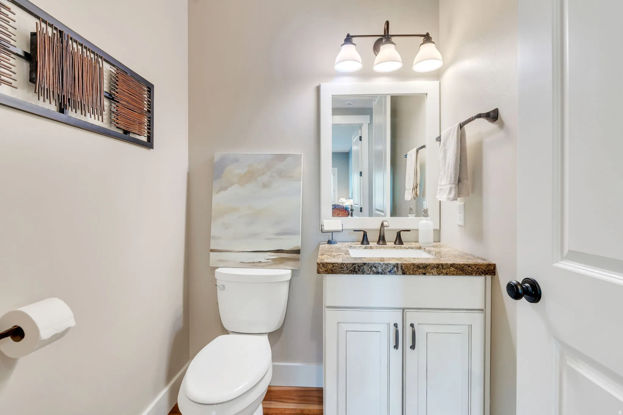 Vanity with cabinet storage, integrated sink, and stone-finish countertop