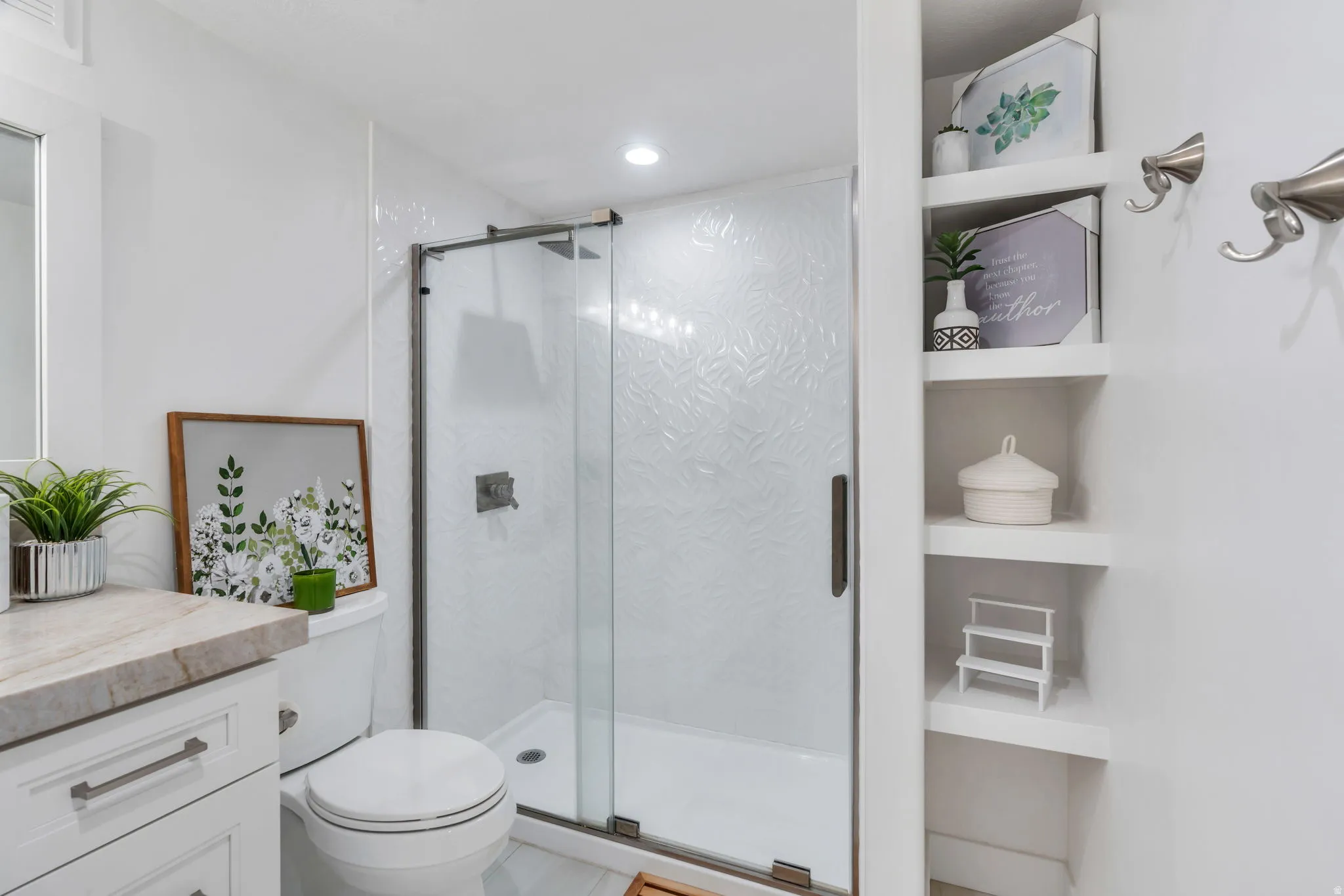Glass-enclosed shower with textured tile surround