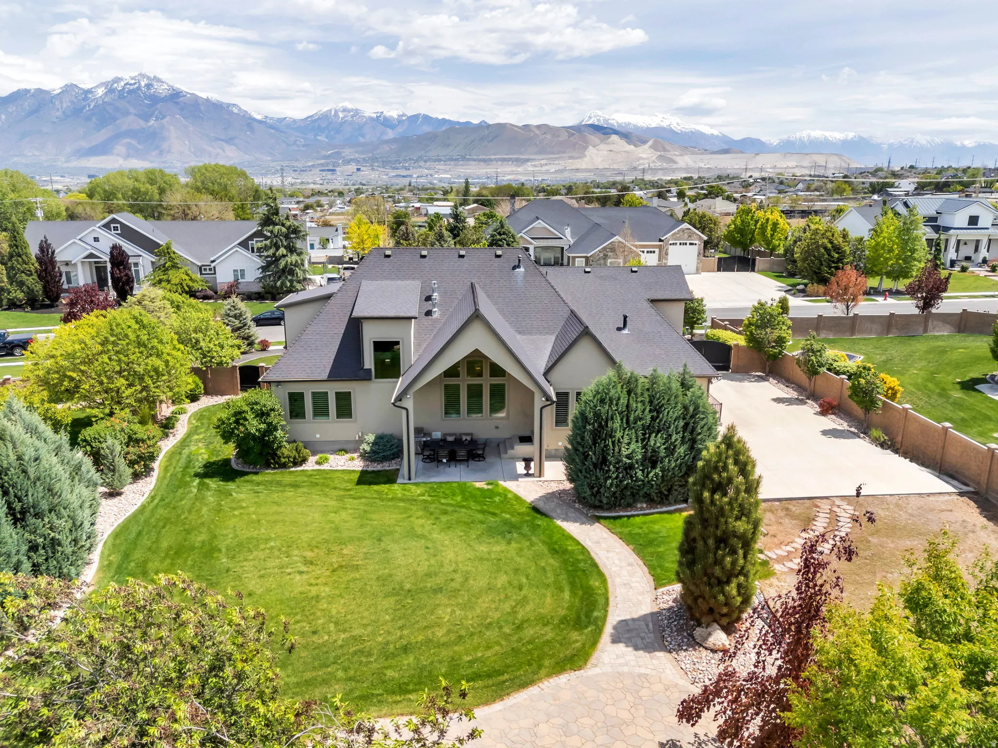 Contemporary residence featuring a multi-gabled roofline and light-toned stucco exterior
