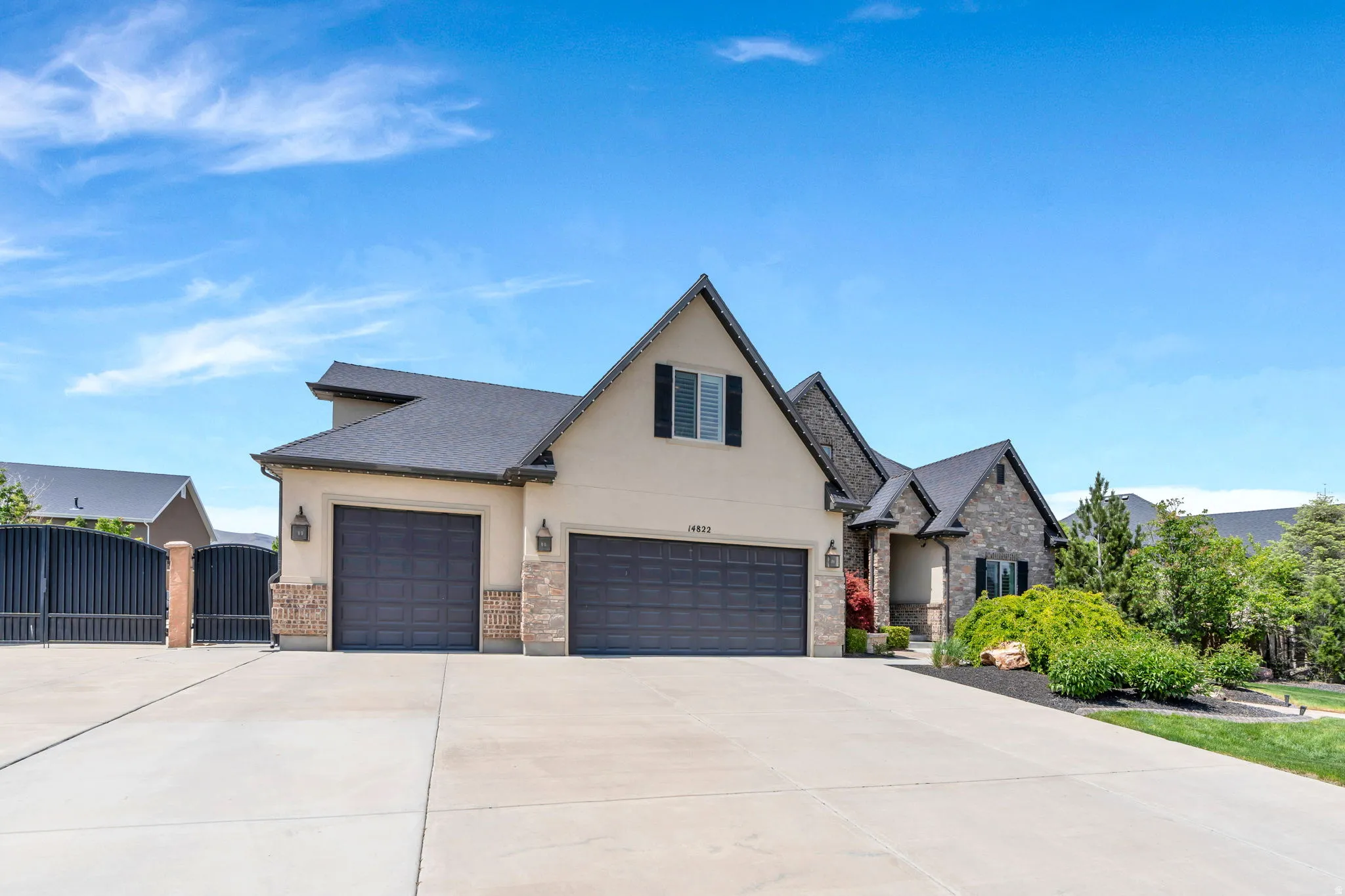 Exterior facade featuring a combination of stucco and stone cladding