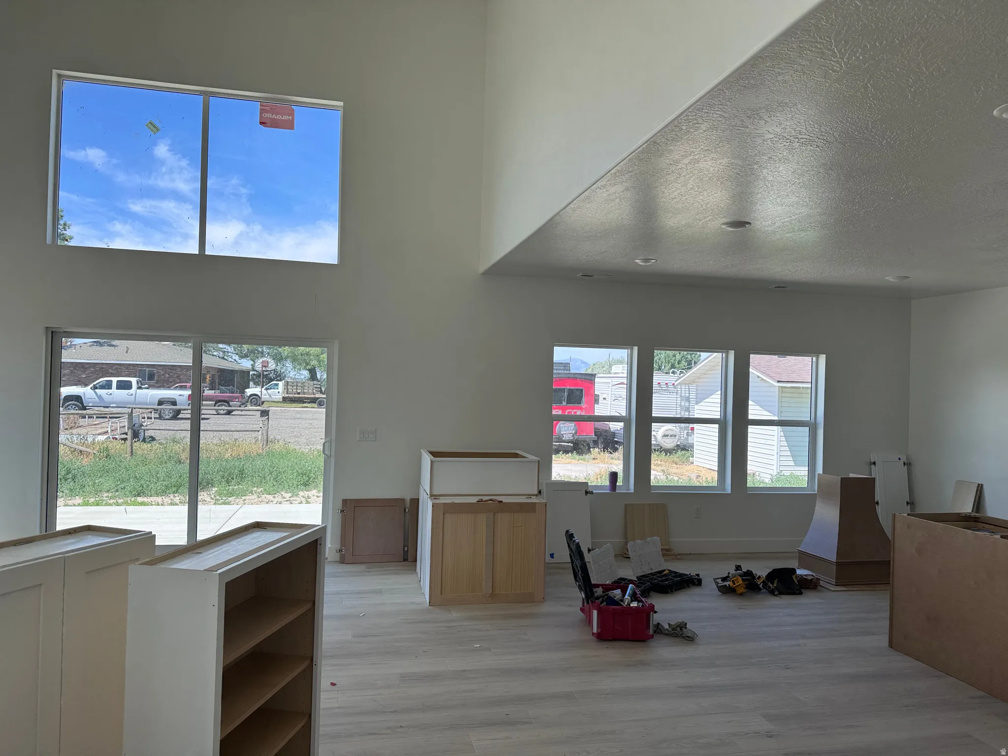 Spacious interior featuring a vaulted ceiling and contemporary light wood-finish flooring