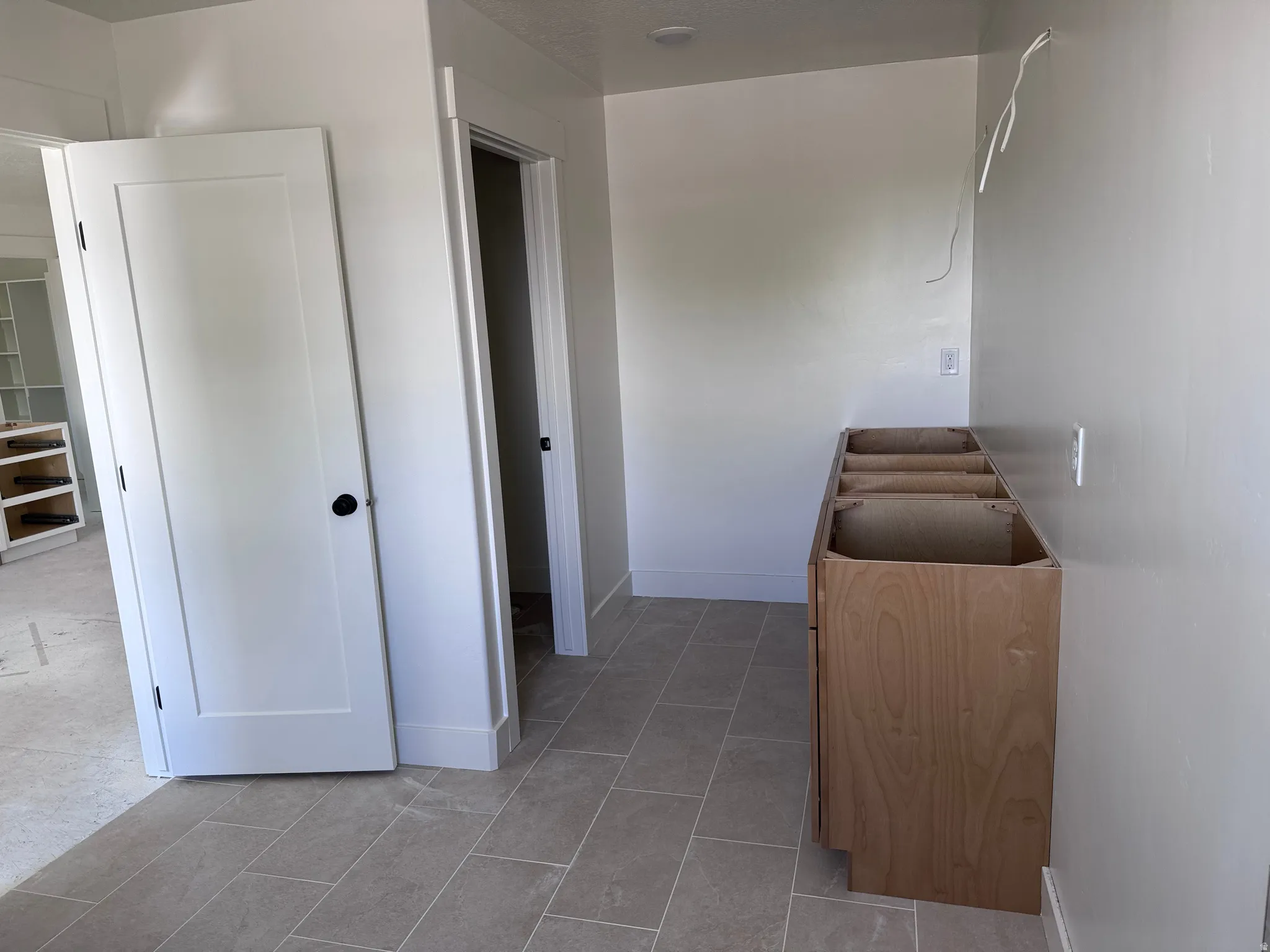 Modern interior featuring light gray rectangular floor tiles and a neutral wall paint palette