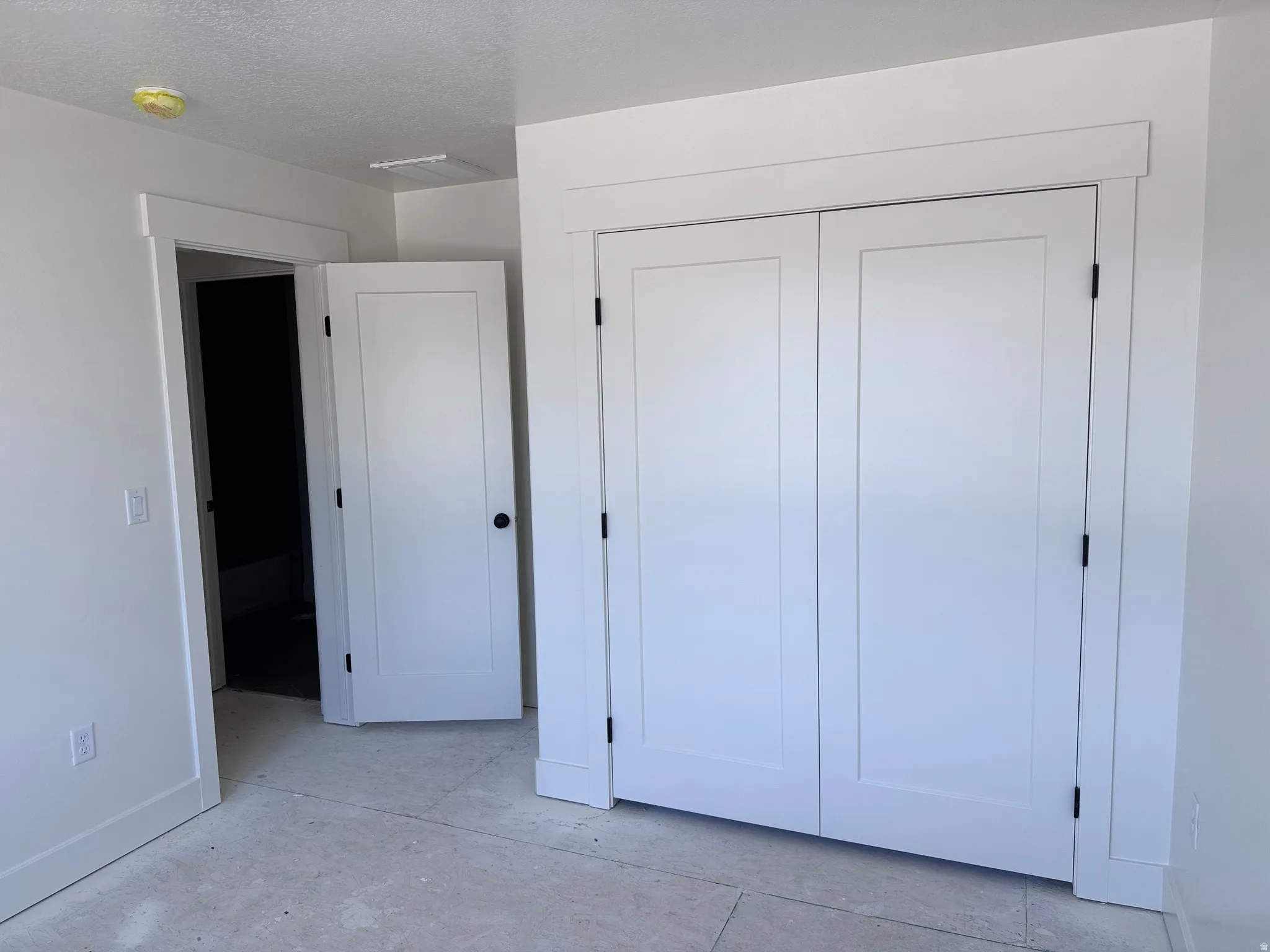 White bi-fold closet doors with black hardware