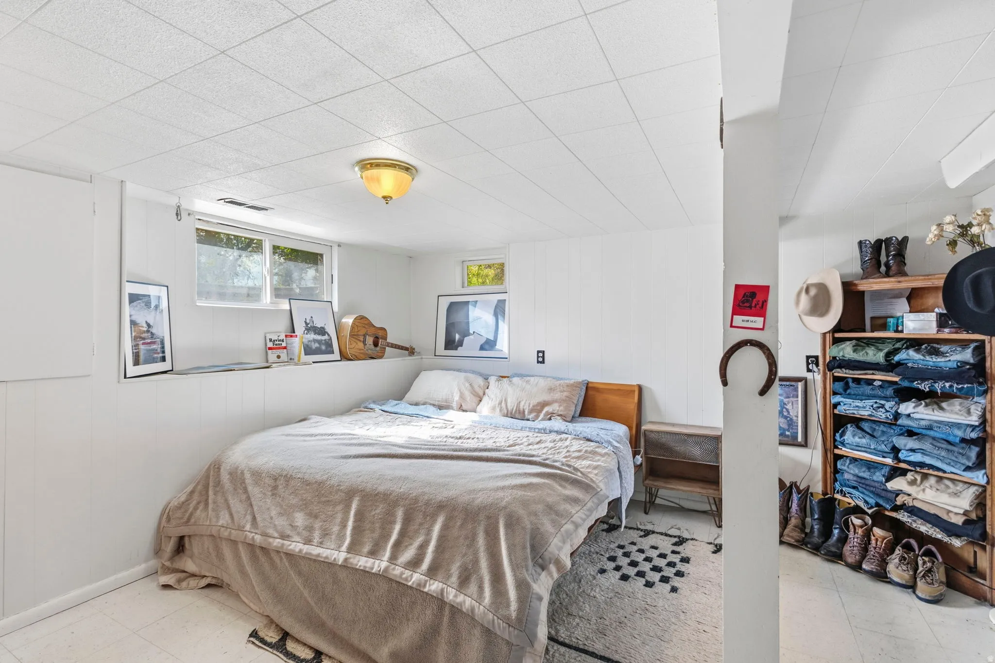 White paneling and drop ceiling with recessed lighting
