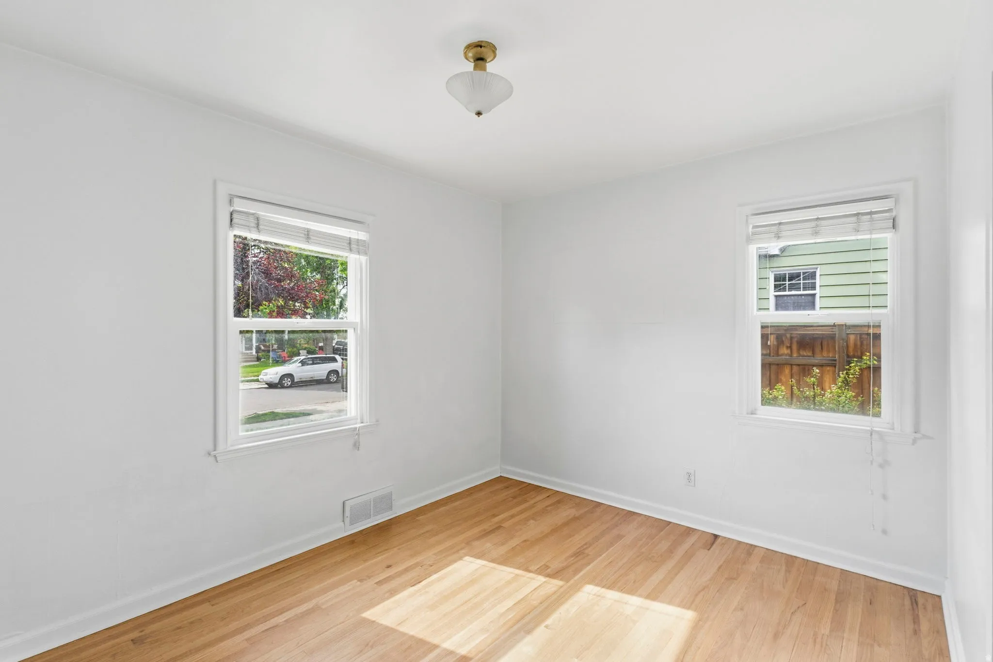 Hardwood flooring complements bright white walls and trim