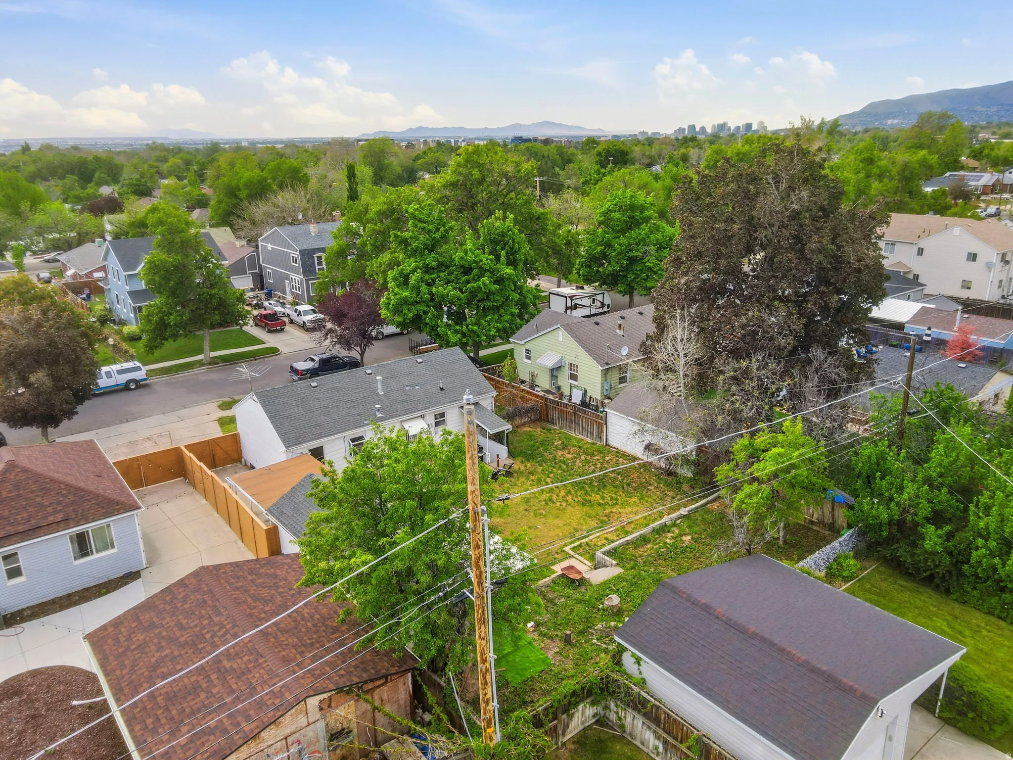 Aerial perspective showcasing a residential neighborhood with varied home styles and mature trees