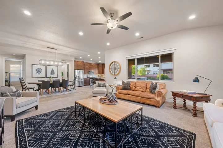 Living room featuring light colored carpet, ceiling fan, and recessed lighting