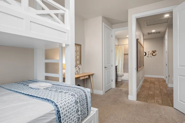 Bedroom with light carpet and recessed lighting