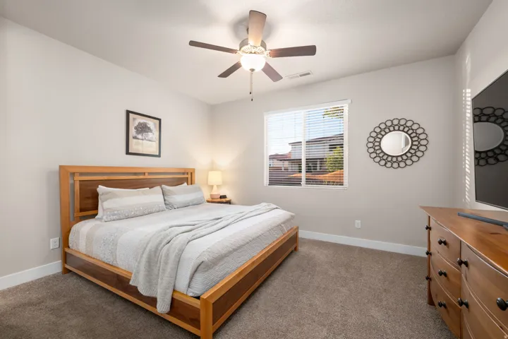 Carpeted bedroom with baseboards and ceiling fan