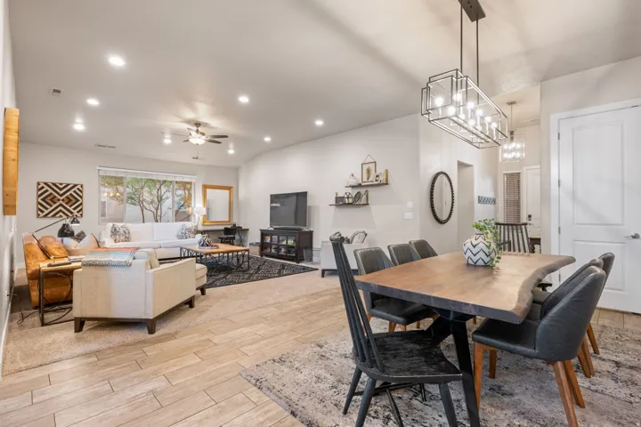 Dining area featuring wood tiled floors, ceiling fan, and recessed lighting