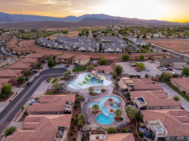 Aerial view at dusk of a residential view, view of pool area, and a mountain view