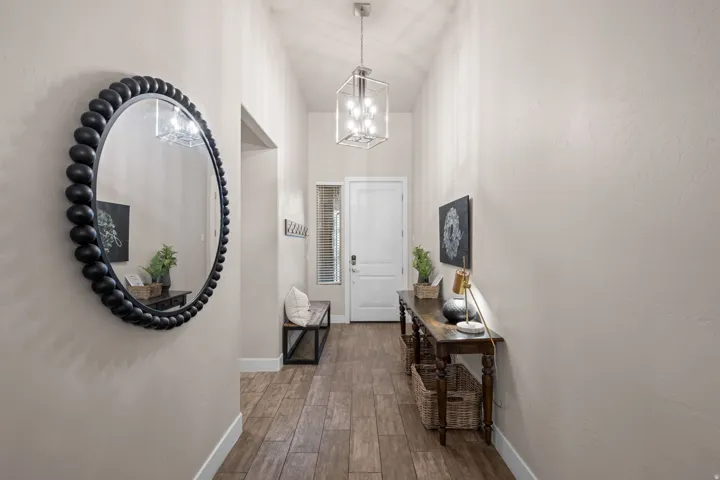 Entrance foyer with dark wood-type flooring and a chandelier