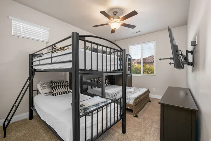 Bedroom featuring light carpet and ceiling fan