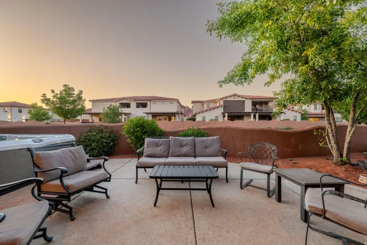Fenced backyard with outdoor lounge area, a patio, and a residential view