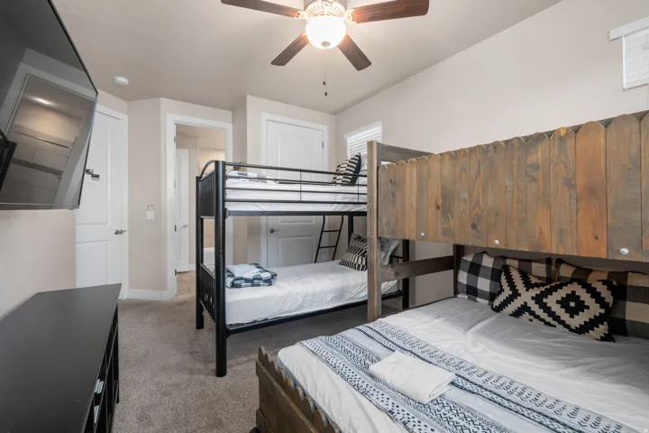 Bedroom with carpet and a ceiling fan