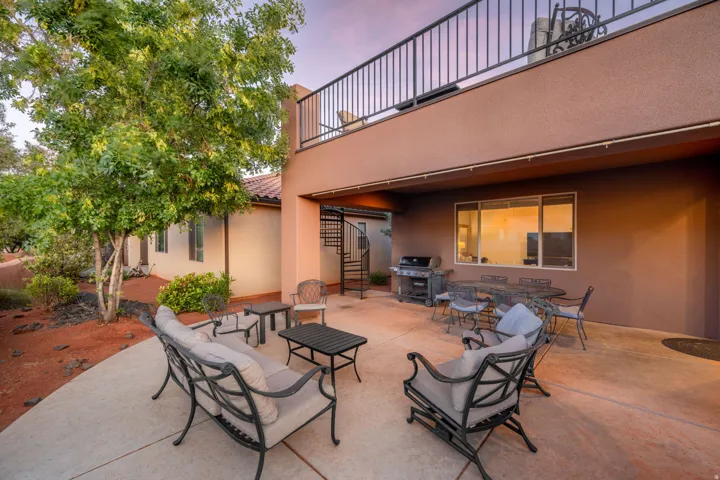 Patio terrace at dusk featuring a grill, a patio area, and outdoor dining space